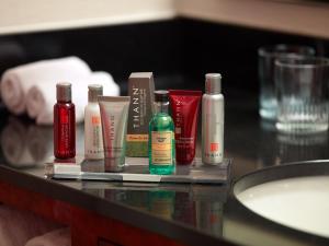 a counter with several bottles ofodorizers and a sink at Atlanta Marriott Northwest at Galleria in Atlanta