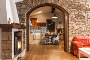an archway leading into a kitchen and living room with a fireplace at Casolare Santa Margherita in Assisi