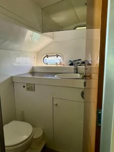a small bathroom with a toilet and a sink at Barco apartamento in El Portil +10 photos