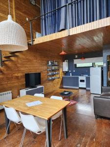 a dining room and kitchen with a table and chairs at Casa Cortés Golf - Boutique in Sierra de la Ventana