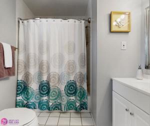 a bathroom with a toilet and a shower curtain at Beach Rd, 300ft to Beach Access & 500ft to Siesta Key Village, 2bdr in Siesta Key +31 photos