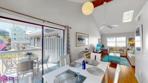 a living room with a dining table and a balcony at Beach Rd, 300ft to Beach Access & 500ft to Siesta Key Village, 2bdr in Siesta Key