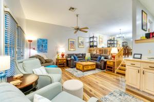 a living room with a couch and a table at Sunny Titusville Retreat Near Space Coast! in Titusville