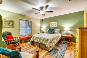 a bedroom with a bed and a ceiling fan at Sunny Titusville Retreat Near Space Coast! in Titusville +27 photos