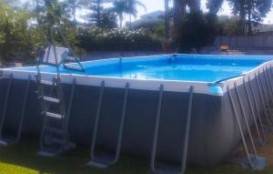 a chair in a pool with a ladder next to it at Nice Home In Siracusa With Wifi in Siracusa