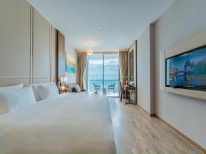 a large bedroom with a large bed and a tv at Panorama Apartment Luxury - Căn Hộ Panorama View Biển in Nha Trang
