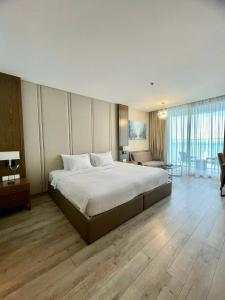 a bedroom with a large bed and a living room at Panorama Apartment Luxury - Căn Hộ Panorama View Biển in Nha Trang