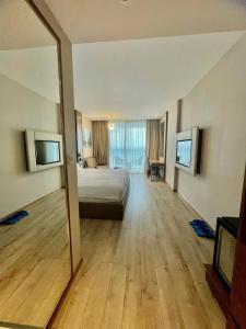 a large bedroom with a bed and a large mirror at Panorama Apartment Luxury - Căn Hộ Panorama View Biển in Nha Trang +15 photos