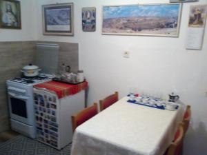 a kitchen with a table and a stove and a table and a table at Hotel Premiér Poprad 13 Jeseň vo Vysokých Tatrách in Poprad