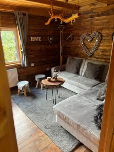 a living room with a couch and a table at Fischer Hütte in Sankt Andreasberg