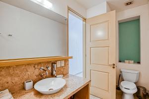 a bathroom with a sink and a toilet at Taheima 2104B at El Tigre in Nuevo Vallarta  +28 photos