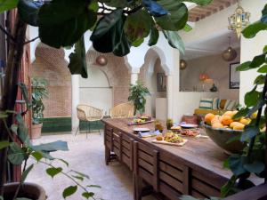 a living room with a table with food on it at Riad Alena in Marrakesh