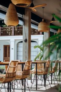 a group of chairs and tables in a restaurant at The Salty Pelican Yoga & Surf Retreat in Dickwella