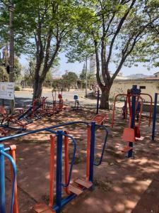 an empty playground in a park with trees at Casa Holiday No pé da serra do Itaqueri com piscina in São Pedro