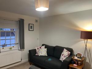 a living room with a couch and a window at The Eaves, Glastonbury High Street 2 bed 2 bathroom apartment in Glastonbury +23 photos