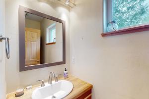 a bathroom with a sink and a mirror at Serene Mountain Escape in Silverthorne +17 photos