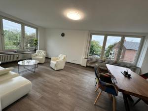 a living room with a couch and a table at Haus am Bahnhof in Duisburg
