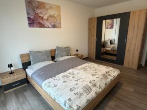 a bedroom with a large bed and a mirror at Haus am Bahnhof in Duisburg