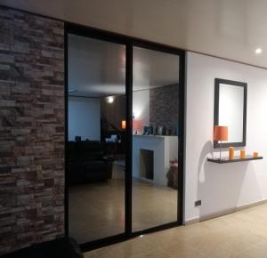 a living room with glass doors and a brick wall at Green life in San Salvador