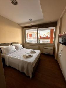 Un dormitorio con una cama y una ventana grande. en The rabbits' house, en Nauplia 52 fotos más