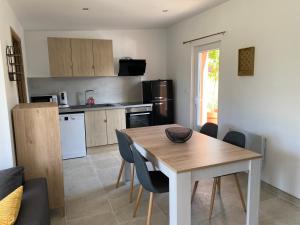 a kitchen and dining room with a table and chairs at Un séjour à la ferme in Sommery