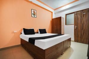 Postel nebo postele na pokoji v ubytování Hotel O Harmony