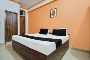 Postel nebo postele na pokoji v ubytování Hotel O Harmony
