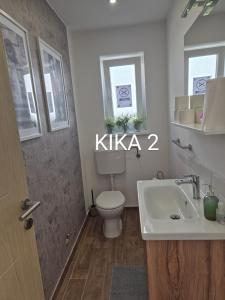 a bathroom with a toilet and a sink at Kika apartmani-FREE PARKING- 7 km od centra in Zagreb +55 photos