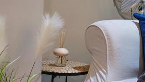 a table with a vase with feathers on it at Stylish 2 Bedroom Apartment, Leeds Centre + Free Parking in Leeds