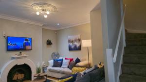 a living room with a couch and a fireplace at Stylish 2 Bedroom Apartment, Leeds Centre + Free Parking in Leeds