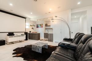 a living room with a couch and a projection screen at Breathtaking 6BD Riverfront Mansion w Pool in Cape Coral