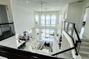 an aerial view of a living room with white furniture at Breathtaking 6BD Riverfront Mansion w Pool in Cape Coral