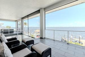 a living room with a view of the ocean at Breathtaking 6BD Riverfront Mansion w Pool in Cape Coral
