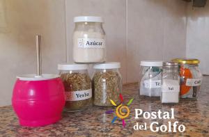 a counter with jars of food on a counter top at Postal del Golfo in Las Grutas