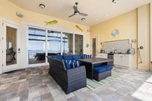 a living room with a blue couch and a table at Peace River Waterfront Luxury Living - 5-BD w Pool in Port Charlotte