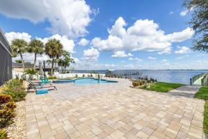 a swimming pool with a view of the water at Peace River Waterfront Luxury Living - 5-BD w Pool in Port Charlotte