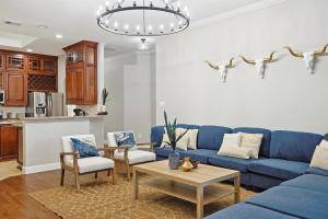 a living room with a blue couch and chairs at 5BD 2BA w Backyard Oasis Pool Jacuzzi Firepit in Corinth +38 photos