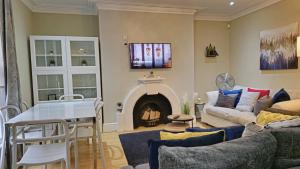 a living room with a couch and a fireplace at Stylish 2 Bedroom Apartment, Leeds Centre + Free Parking in Leeds +18 photos