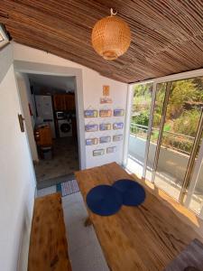 a room with a wooden table and a large window at Lovely newly refurbished, 1 bedroom top floor apartment with sea views, fast WI-FI CABLE TV and Netflix in Ribeira Brava +28 photos