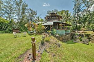 a building with a dome on top of a field at Tropical Cabana with Deck, Hot Tub and Lush Scenery! in Keaau