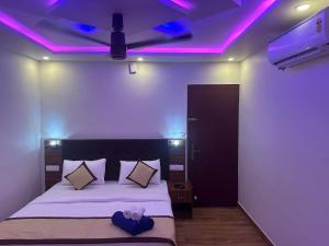 a bedroom with a bed with purple lights on the ceiling at Golden hills cottage in Viripara