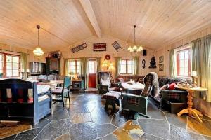 a living room filled with furniture and a table at Flott hytte på Lifjell in Lifjell