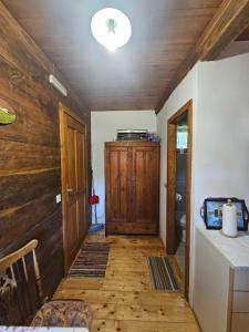 a hallway of a house with a wooden floor and a ceiling at Apartments Kuvarna in Čigoč