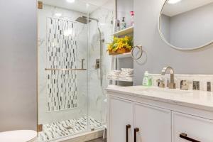 a white bathroom with a shower and a sink at half Mi to Ogunquit Beach Maine Home with Deck! in Ogunquit +24 photos