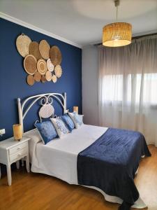 a bedroom with a bed with hats on the wall at A Las faldas del Tecla in A Guarda