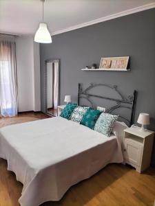 a bedroom with a large bed with pillows on it at A Las faldas del Tecla in A Guarda +13 photos