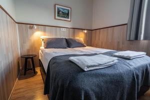 a bedroom with a bed with two towels on it at Hotel Skaftafell in Skaftafell