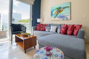 a living room with a couch and a table at papaya 15 Exclusive PentHouse with rooftop and jacuzzi in Playa del Carmen