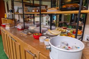a kitchen with a counter with food on it at Refúgio da Enseada - Suítes in Ubatuba +91 photos