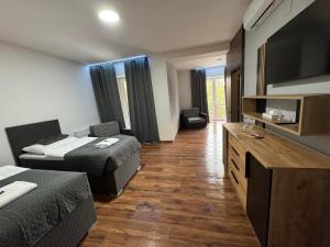 a hotel room with two beds and a television at Vrbecká restaurace - penzion 5 in Hrubá Vrbka